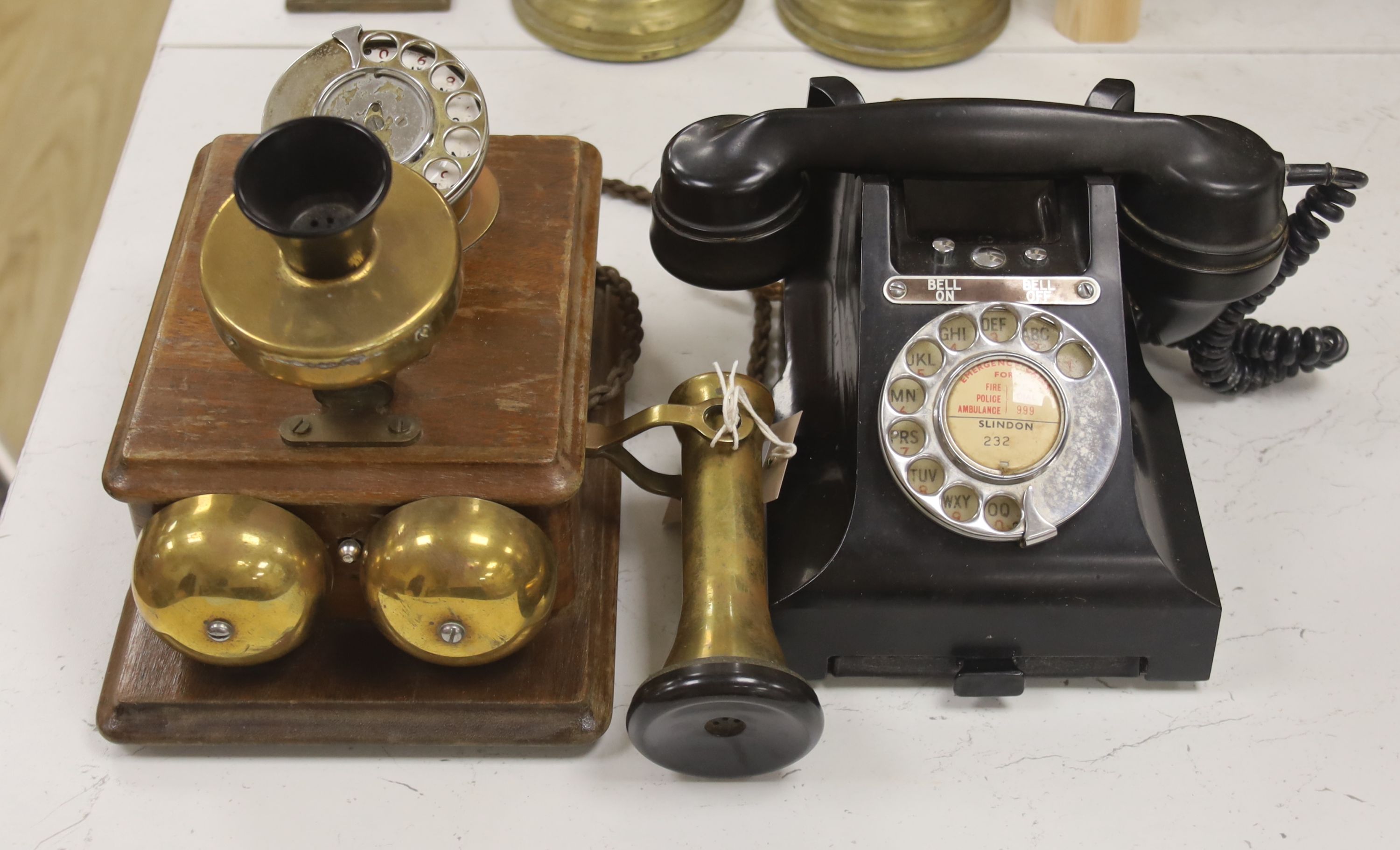 A 20th century black bakelite telephone, Slindon 232, the receiver marked 164-48, together with a further early timber cased telephone